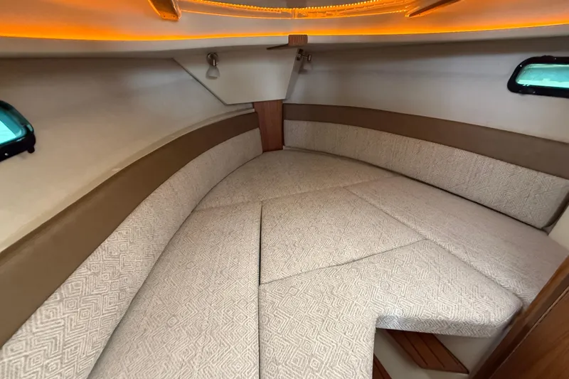  Yacht Photos Pics 2025 Ranger Tugs R-27 cabin interior with cozy V-berth and ambient lighting.