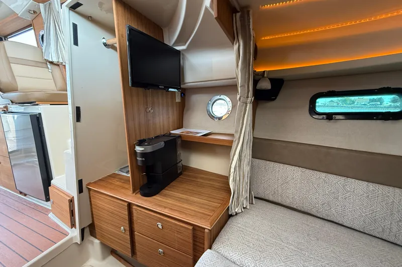  Yacht Photos Pics 2025 Ranger Tugs R-27 interior with TV, coffee maker, and cozy seating area.