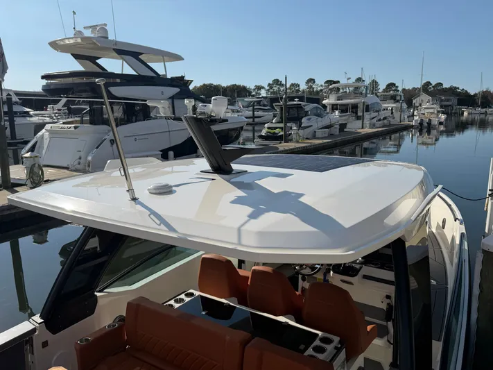  Yacht Photos Pics Saxdor 320 GTO 2025 in a marina, surrounded by other boats.