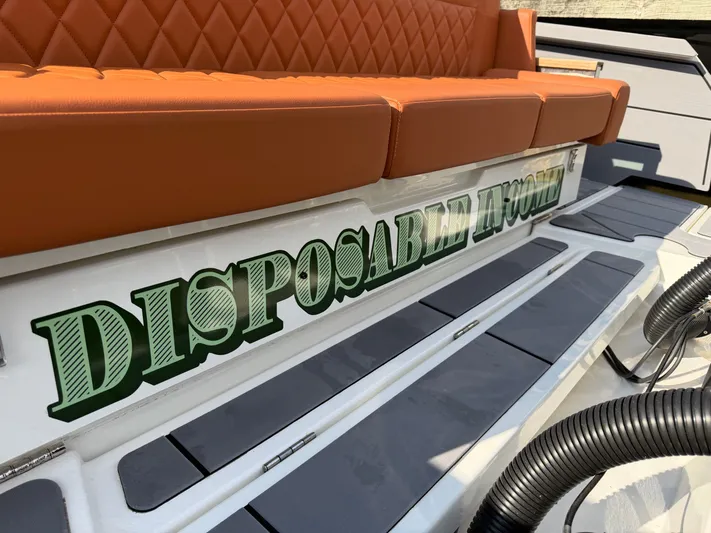 Yacht Photos Pics Saxdor 320 GTO 2025 with "DISPOSABLE INCOME" lettering and orange seating.