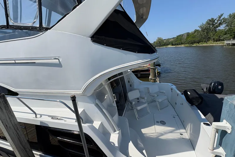 Elevate Yacht Photos Pics 2003 Carver 360 Sport Sedan yacht docked by a serene waterfront.