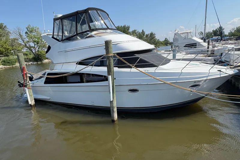 Elevate Yacht Photos Pics 2003 Carver 360 Sport Sedan yacht docked at marina, side view.