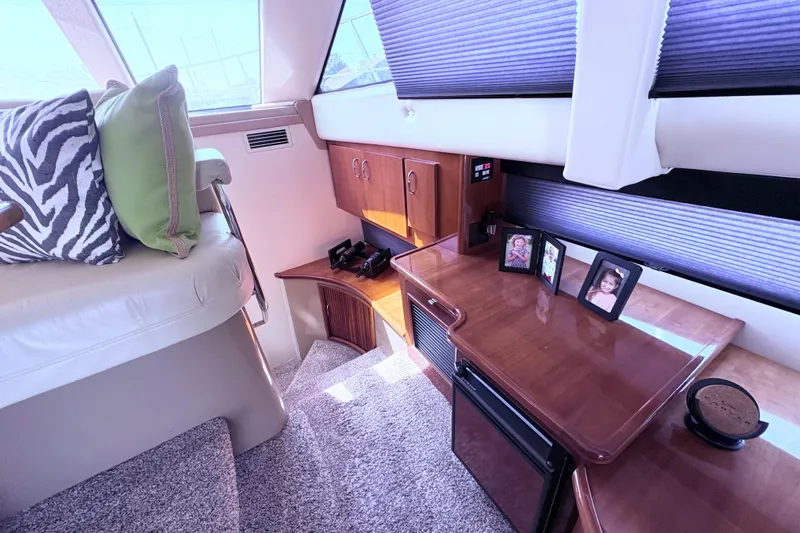 Elevate Yacht Photos Pics Interior of 2003 Carver 360 Sport Sedan with cozy seating and wooden cabinetry.