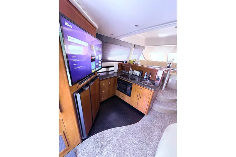 Elevate Yacht Photos Pics Luxurious interior of 2003 Carver 360 Sport Sedan with modern kitchen and entertainment system.