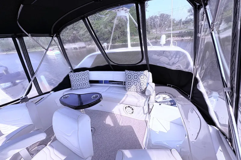 Elevate Yacht Photos Pics Interior of 2003 Carver 360 Sport Sedan with seating and table, overlooking water.