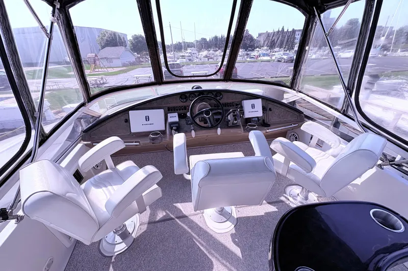 Elevate Yacht Photos Pics Interior of 2003 Carver 360 Sport Sedan yacht with white seating and navigation controls.