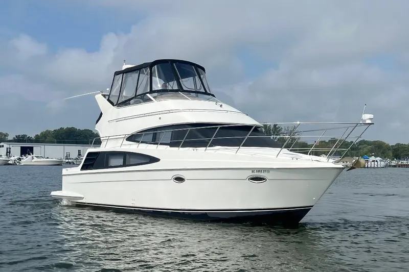 Elevate Yacht Photos Pics 2003 Carver 360 Sport Sedan yacht on calm water under a cloudy sky.