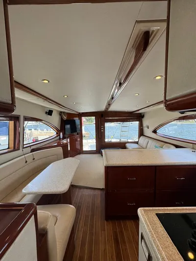 Spill Yacht Photos Pics Interior of a 2007 Bertram 510 Convertible yacht with elegant seating and wooden flooring.