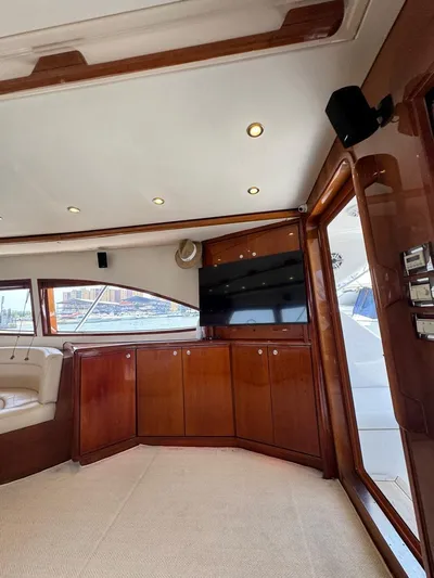 Spill Yacht Photos Pics Interior of a 2007 Bertram 510 Convertible yacht with wood cabinetry and a flat-screen TV.