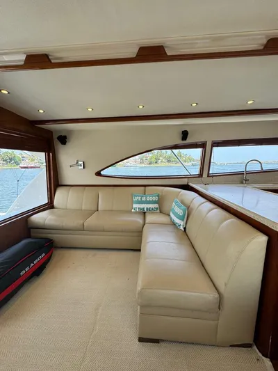 Spill Yacht Photos Pics Interior of 2007 Bertram 510 Convertible yacht with beige leather seating and ocean view.