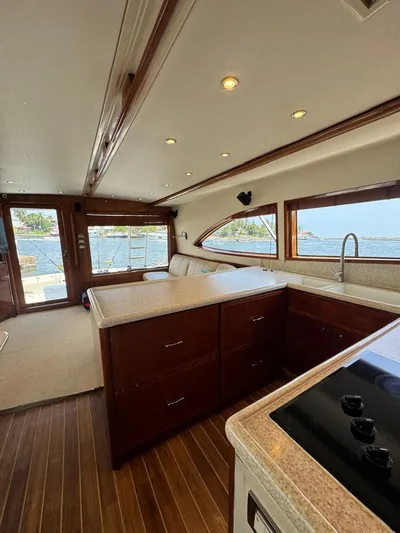 Spill Yacht Photos Pics Interior of a 2007 Bertram 510 Convertible yacht with wooden cabinetry and ocean view.