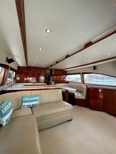 Spill Yacht Photos Pics Luxurious interior of a 2007 Bertram 510 Convertible yacht with leather seating and wooden finishes.
