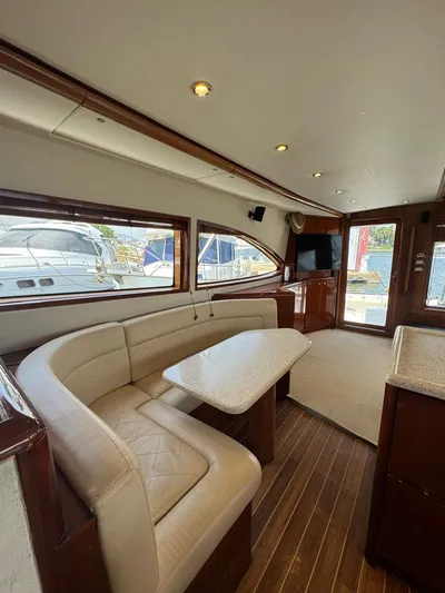 Spill Yacht Photos Pics 2007 Bertram 510 Convertible yacht interior with dining area and large windows.