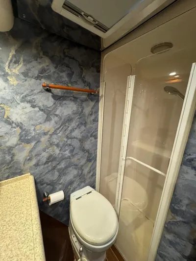 Spill Yacht Photos Pics Bathroom interior of a 2007 Bertram 510 Convertible yacht with shower and toilet.