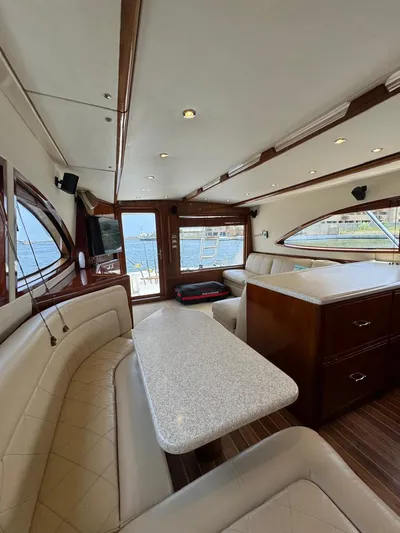 Spill Yacht Photos Pics Interior of 2007 Bertram 510 Convertible yacht with luxurious seating and dining area.