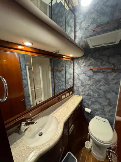 Spill Yacht Photos Pics Luxurious bathroom in a 2007 Bertram 510 Convertible yacht with modern fixtures and ample storage.