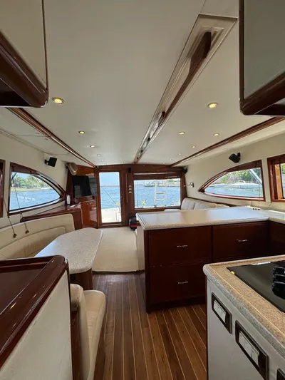 Spill Yacht Photos Pics Interior of a 2007 Bertram 510 Convertible yacht with wooden flooring and modern furnishings.