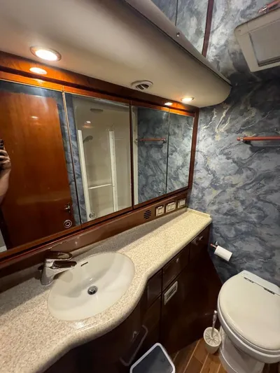 Spill Yacht Photos Pics Luxurious bathroom in a 2007 Bertram 510 Convertible yacht with modern fixtures.