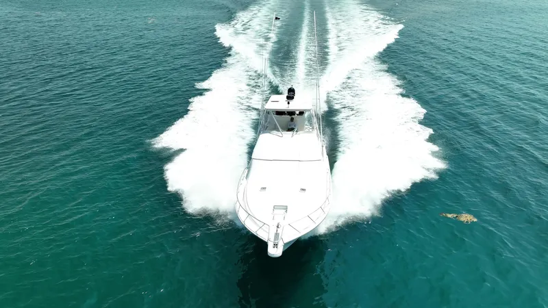 Spill Yacht Photos Pics 2007 Bertram 510 Convertible cruising on clear blue water.