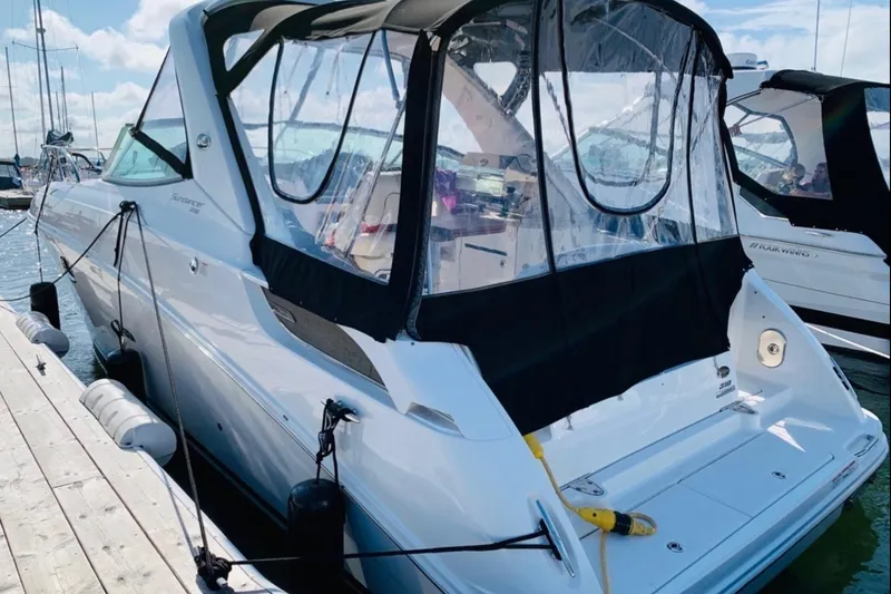  Yacht Photos Pics 2011 Sea Ray 310 Sundancer docked at marina, featuring sleek design and protective canopy.