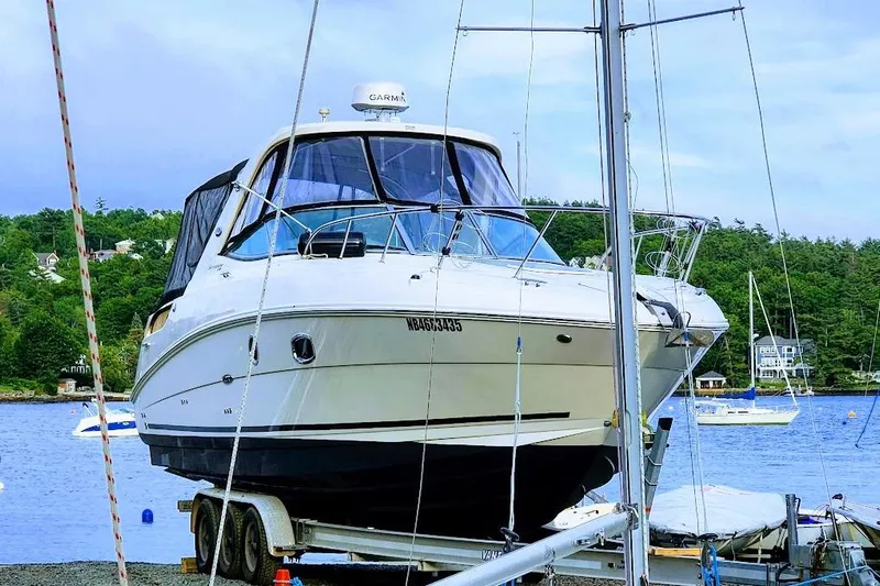  Yacht Photos Pics 2011 Sea Ray 310 Sundancer boat on trailer by a scenic lake.