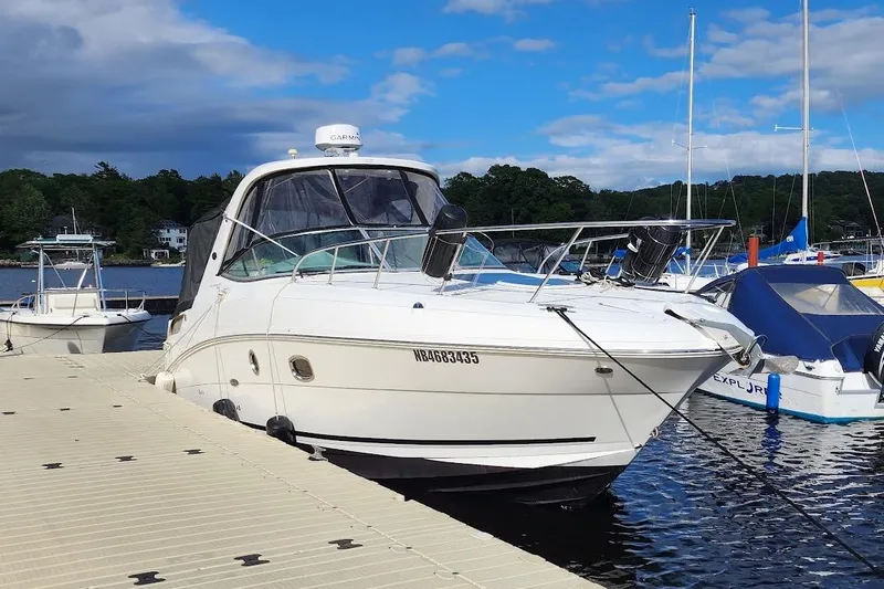  Yacht Photos Pics 2011 Sea Ray 310 Sundancer docked at a marina under a partly cloudy sky.