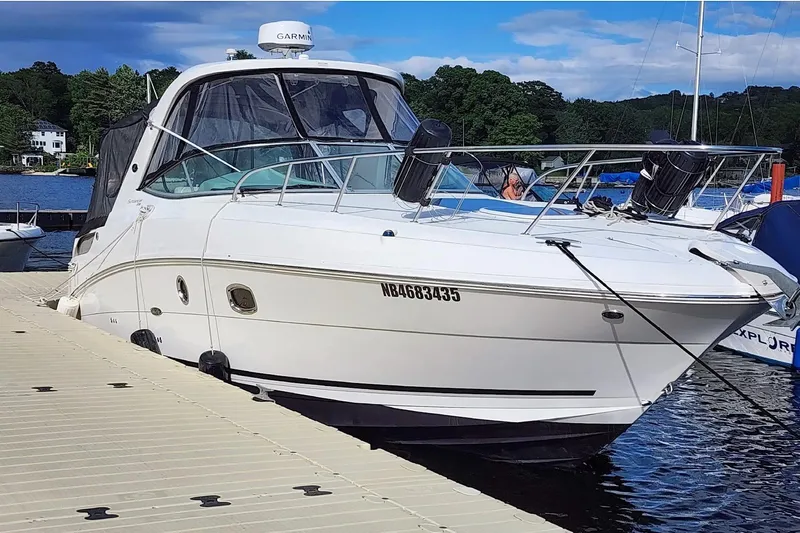  Yacht Photos Pics 2011 Sea Ray 310 Sundancer docked at a marina with scenic background.