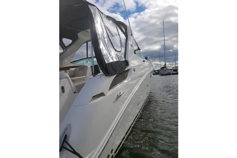  Yacht Photos Pics 2011 Sea Ray 310 Sundancer yacht docked in a marina under cloudy skies.