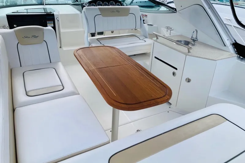  Yacht Photos Pics Interior of 2011 Sea Ray 310 Sundancer with seating, table, and kitchenette.