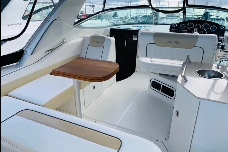  Yacht Photos Pics 2011 Sea Ray 310 Sundancer interior with seating, table, and sink.