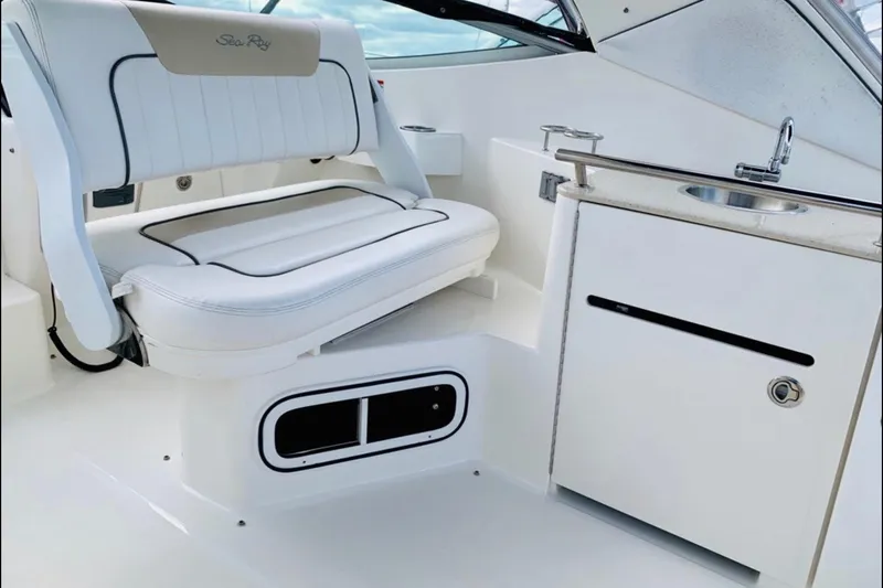  Yacht Photos Pics Interior of 2011 Sea Ray 310 Sundancer with seating and kitchenette area.