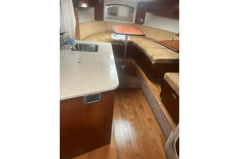  Yacht Photos Pics Interior of 2011 Sea Ray 310 Sundancer with kitchenette and seating area.