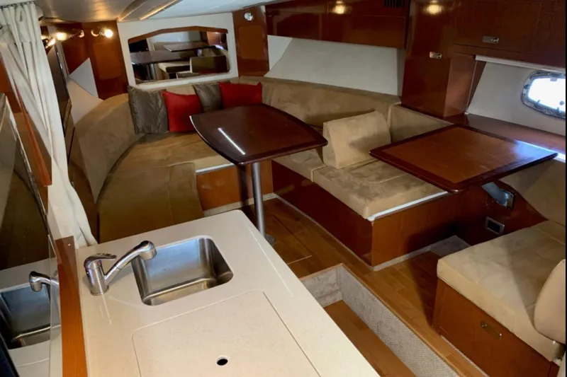  Yacht Photos Pics Interior of 2011 Sea Ray 310 Sundancer yacht with cozy seating and kitchenette.