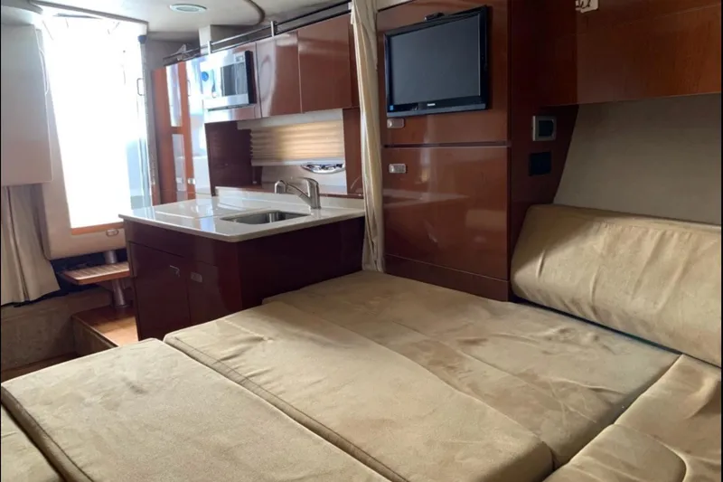  Yacht Photos Pics Interior of 2011 Sea Ray 310 Sundancer yacht with kitchenette and seating area.