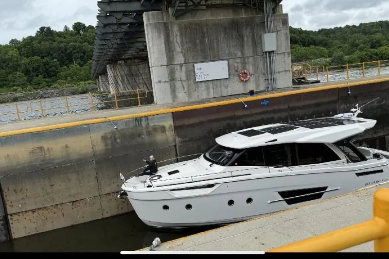 Scotts N Water Yacht Photos Pics 2024 Greenline 45 Coupe Hybrid yacht navigating a lock under a bridge.