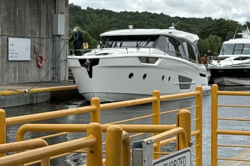 Scotts N Water Yacht Photos Pics 2024 Greenline 45 Coupe Hybrid yacht navigating a lock, surrounded by lush greenery.