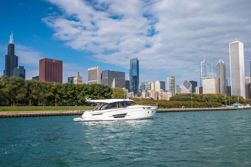 Scotts N Water Yacht Photos Pics 2024 Greenline 45 Coupe Hybrid yacht cruising near city skyline.