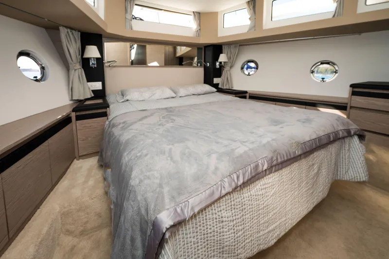 Scotts N Water Yacht Photos Pics Luxurious bedroom interior of 2024 Greenline 45 Coupe Hybrid yacht, featuring elegant design.
