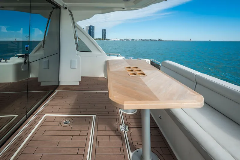 Scotts N Water Yacht Photos Pics 2024 Greenline 45 Coupe Hybrid yacht deck with wooden table, ocean view.