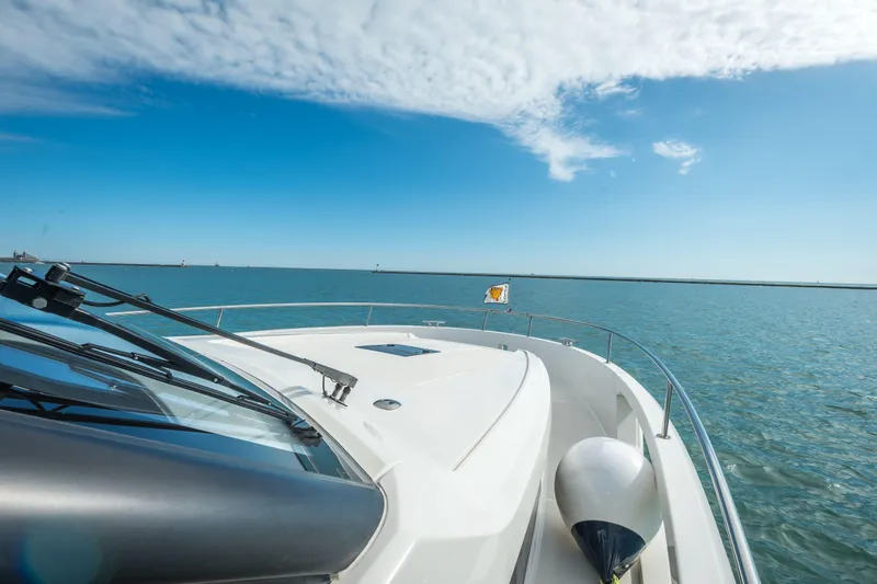 Scotts N Water Yacht Photos Pics 2024 Greenline 45 Coupe Hybrid yacht cruising on open water under a clear blue sky.