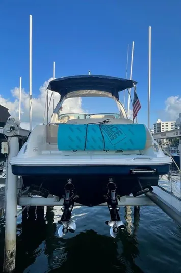  Yacht Photos Pics 2012 Sea Ray 350 Sundancer docked, rear view with blue sky background.
