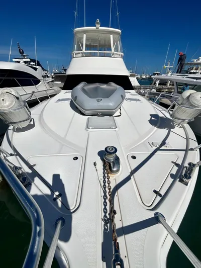  Yacht Photos Pics 2007 Riviera 47 Convertible yacht docked, showcasing spacious deck and sleek design.