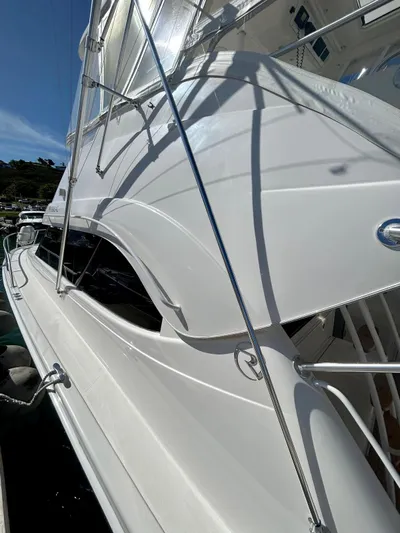  Yacht Photos Pics 2007 Riviera 47 Convertible yacht with sleek white exterior and modern design.