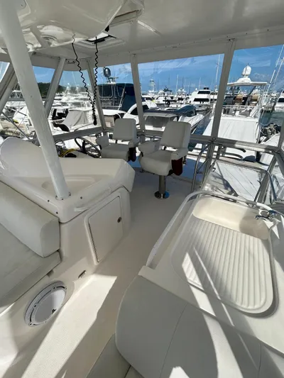  Yacht Photos Pics 2007 Riviera 47 Convertible yacht interior with white seating and marina view.