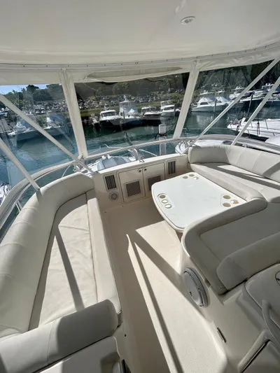  Yacht Photos Pics 2007 Riviera 47 Convertible yacht interior with spacious seating and table, docked at marina.