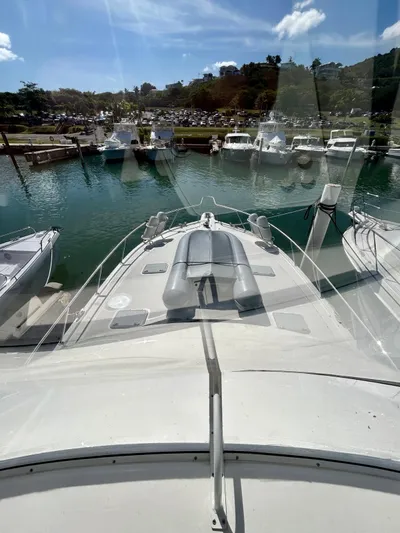  Yacht Photos Pics 2007 Riviera 47 Convertible yacht docked in a sunny marina.