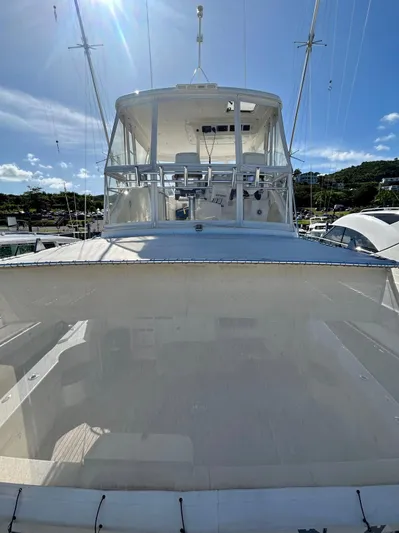  Yacht Photos Pics 2007 Riviera 47 Convertible yacht with flybridge, docked under clear blue sky.