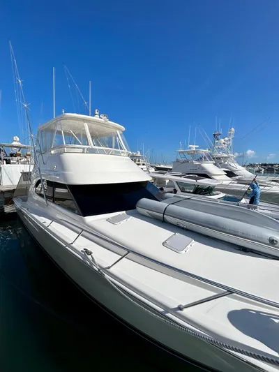  Yacht Photos Pics 2007 Riviera 47 Convertible yacht docked under clear blue sky.