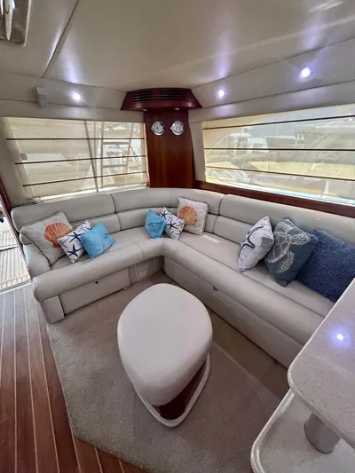  Yacht Photos Pics Luxurious interior of 2007 Riviera 47 Convertible yacht with plush seating and nautical-themed cushions.