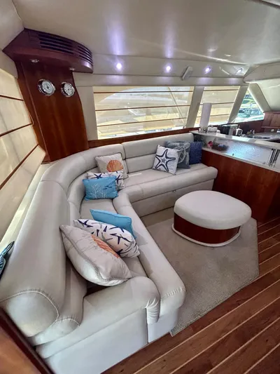  Yacht Photos Pics Luxurious interior of 2007 Riviera 47 Convertible yacht with plush seating and elegant decor.